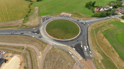 An aerial view of construction works around a roundabout