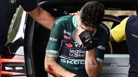 Wout van Aert holds his hand to his head