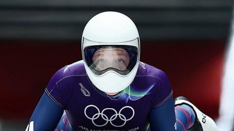Amelia Coltman, Team GB skeleton racer, in action at the Olympic Winter Games in Milan Cortina. Amelia is wearing a helmet to protect her face