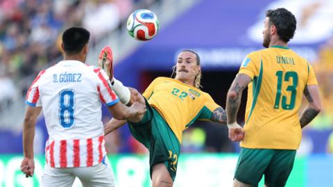 Jackson Irvine #22 of Australia attempts an overhead kick against Diego Gomez #8 of Paraguay during the FIFA World Cup 2026 Group D match between Paraguay and Australia at San Francisco Bay Area Stadium 