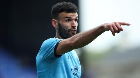 Crewe midfielder Conor Thomas points and shouts during a game