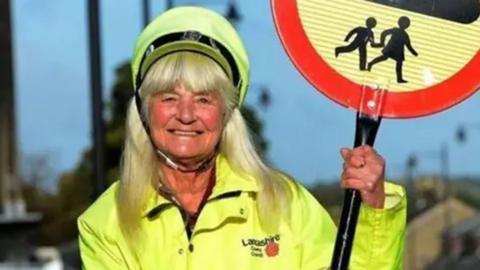 a picture of Irene in her lollipop lady outfit.