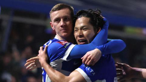 A photo of Birmingham City players Jay Stansfield and Tomoki Iwata in an embrace
