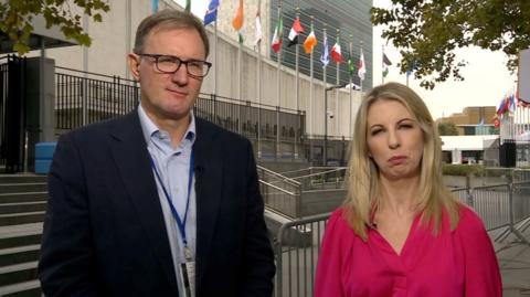 James Landale and Caitriona Perry stood in front of flags outside the UN assembly building