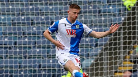 Scott Wharton kicks the ball during a match for Blackburn this season