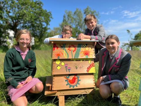 schoolchildren with a painted bee hive