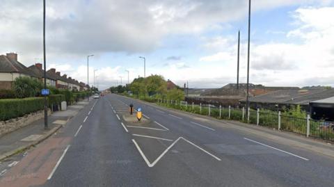 The A630 Fitzwilliam Road in Rotherham. Residential homes run along the road on the left while a garage is on the right. 