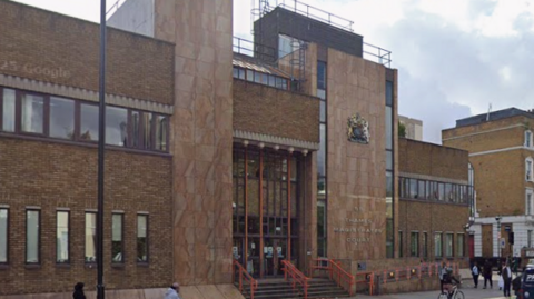 An interior shot of Thames Magistrates' Court building - a large, brown stone building.