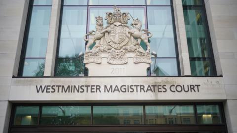 A general view of the entrance to Westminster Magistrates Court. The name of the court is written on the front of the building above an entrance. The HM Courts and Tribunal Service embled rests above the court name.