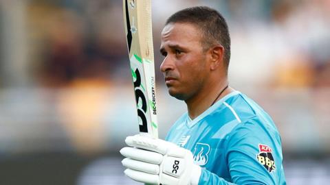 Usman Khawaja celebrates his half-century for Brisbane Heat against Sydney Thunder in the Big Bash League
