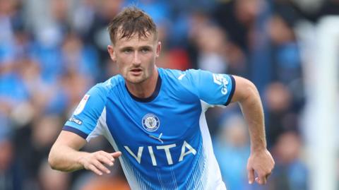 Stockport's Callum Connolly in action