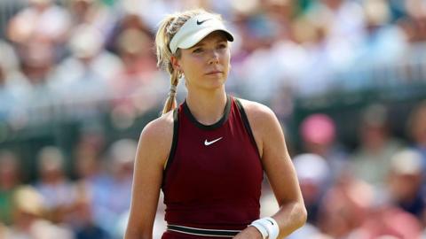 Tennis player Katie Boulter looks on while on court during a match.