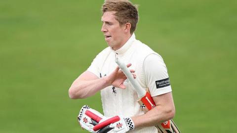 Zak Crawley walks back dejectedly after being dismissed in county cricket