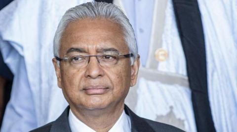 A head and shoulders shot of Pravind Jugnauth wearing a dark jacket and white shirt.