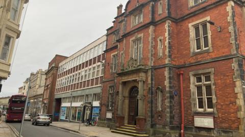 A street in Scarborough town centre, with the town hall and a bus visible