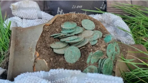 The coins inside the broken clay pot 