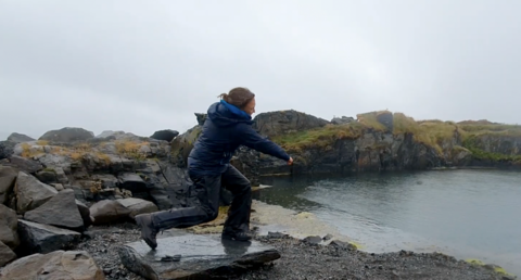 Stone skimmer Lucy throws a stone into water
