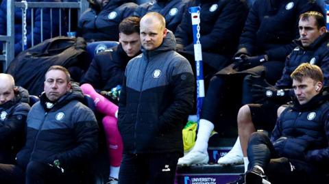 Liam Manning looking on form the touchline against Portsmouth