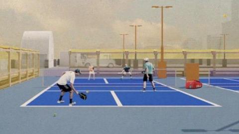 An artwork of four people playing pickleball on a blue court with tall flood lights and barriers around the edge.