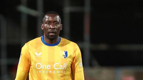 Lucas Akins in action for Mansfield against Wigan