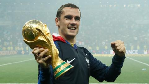 France forward Antoine Griezmann holding the World Cup trophy