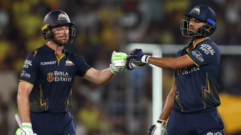 Jos Buttler punches gloves with Washington Sundar