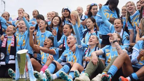 Manchester City players celebrate winning the WSL