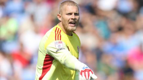 Footballer Connor Ripley playing as goalkeeper for League Two football club Swindon Town