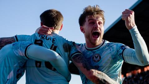 James Crole of Newport County celebrates his goal with Ben Lloyd