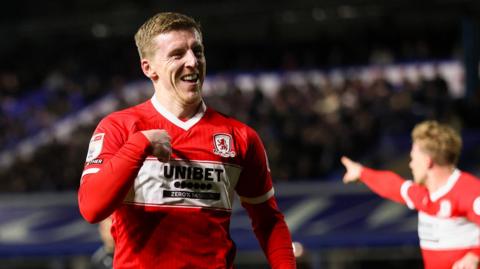 Matt Targett pointing at himself with his right hand after scoring for Middlesbrough. He has a big smile on his face.
