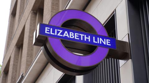 A purple Elizabeth line roundel 