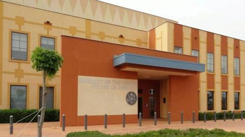 A front view of the US embassy in Ouagadougou. It is coloured brown and yellow