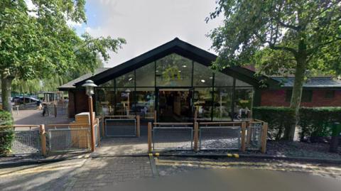 The outside of the Bracknell McDonalds trees can be seen either side of the entrance