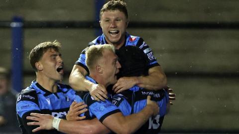 Cardiff celebrate after Evan Lloyd's first try in the win against Lions