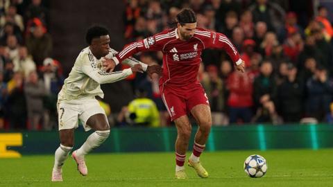 Dominik Szoboszlai and Vinicius Junior battle for the ball at Anfield