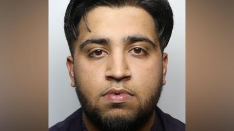 Mugshot of Sohail Jahangir who has black hair and a beard.