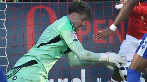 Matty Young, of Salford City, makes a goalline save