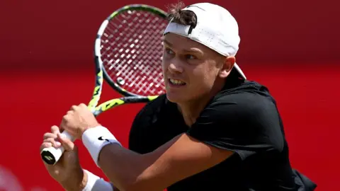 Holger Rune hits the ball