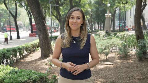 Sarah Dawkins, BBC Sport reporter, smiling at camera on the streets of Mexico City