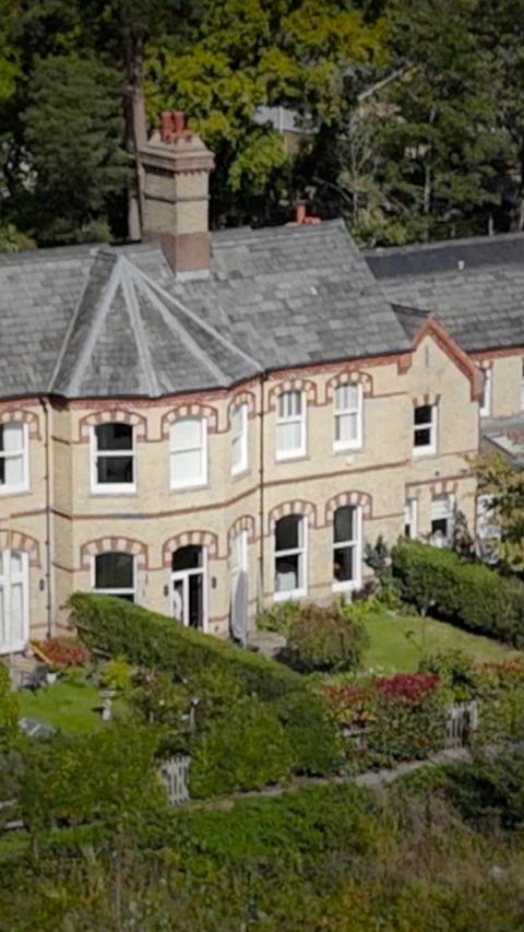 An aerial view of a cream coloured house.