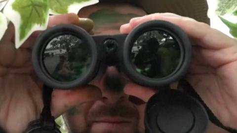 Man in camouflage spying 