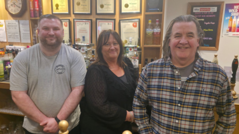 Bar manager Sean Rowbottom, events coordinator and licensee Lisa Moody  and cellarman Tony Hill inside the Billingham Catholic Club. They are pictured behind the bar, and behind them are lots of framed CAMRA awards.