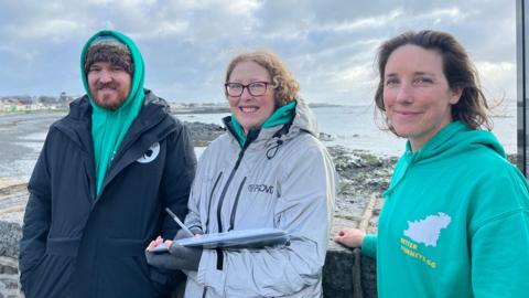 Matt Smart, Ket Lenfesty and Deputy Lindsay de Sausmarez standing infront of the sea wall