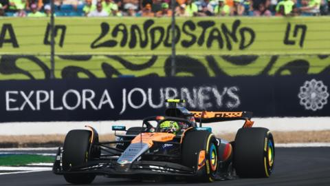 McLaren's Lando Norris in British Grand Prix second practice with the 'Lando stand' in the background