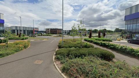 An industrial park with buildings, roads and bushes