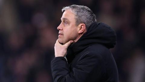 Huddersfield Town boss Michael Duff looking pensive from the touchline with his hand on his chin