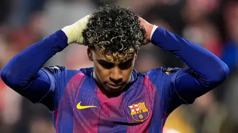 Lamine Yamal puts his hands to his head after missing a penalty