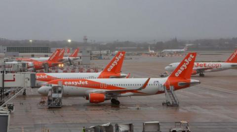 Easyjet planes on the tarmac at Gatwick airport.