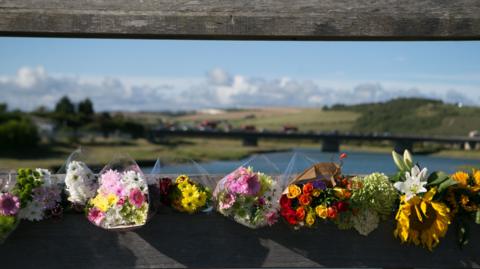 Flowers in tribute to Shoreham air crash victims on a toll bridge close to the crash scene