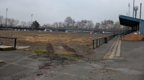 The pitch at Farsley Celtic's ground, which has been torn up and consists entirely of mud.